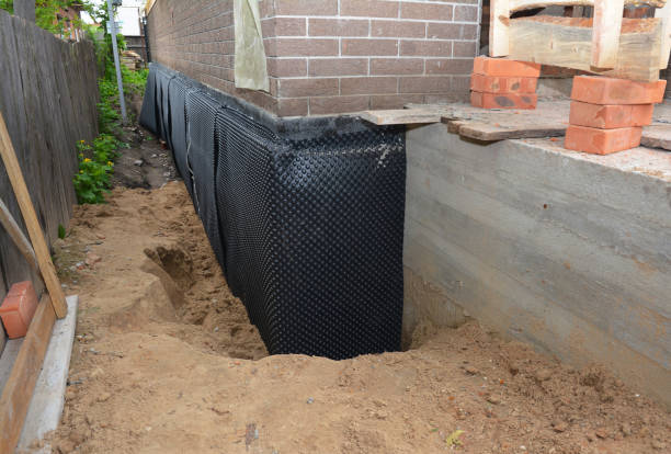 SJ Waterproofing Pros technician performing targeted Wet Basement Repair assessment in Freedom, IN